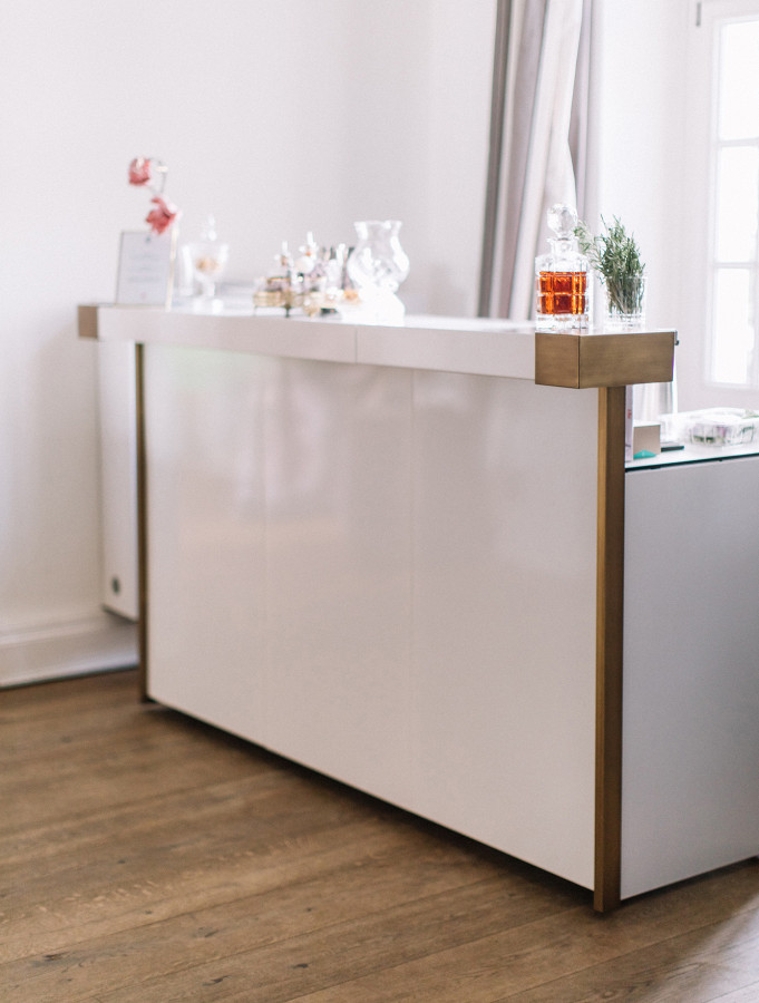 Modern cocktail bar in white with noble brass application in old mansion.
